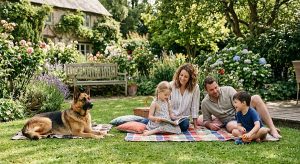 protective family dog resting near children in a garden